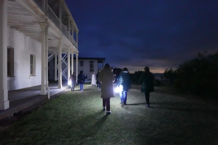 a group of people walking in front of a building